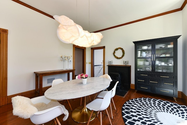 dining area with dark hardwood / wood-style flooring and ornamental molding