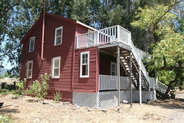 view of side of home with a deck