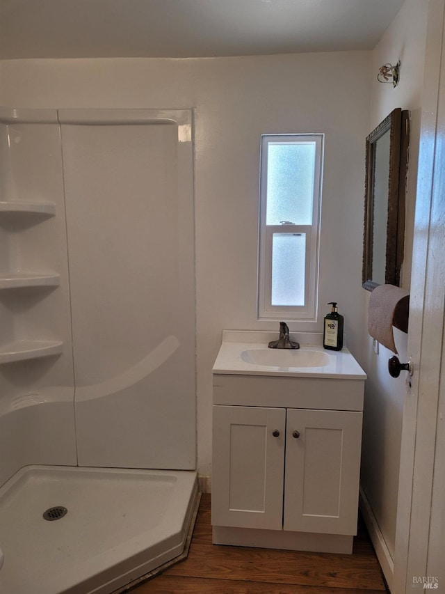 bathroom with vanity, a shower, and hardwood / wood-style floors