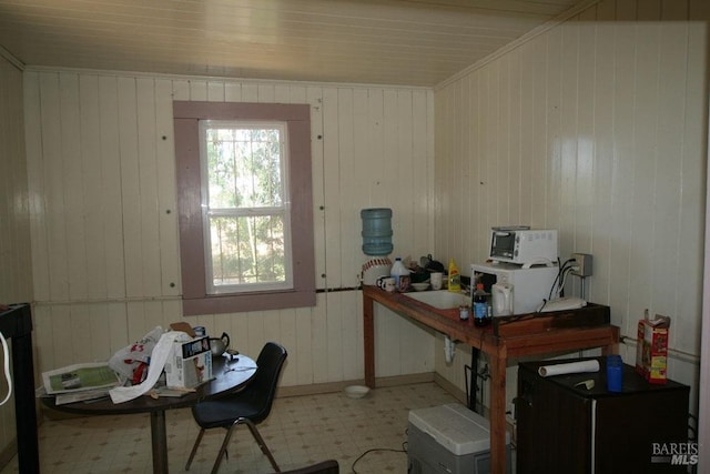 office space featuring wood walls and a workshop area