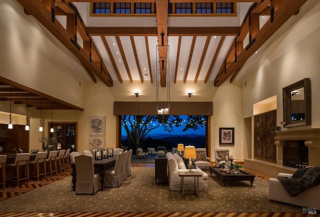 living room with beamed ceiling and a towering ceiling