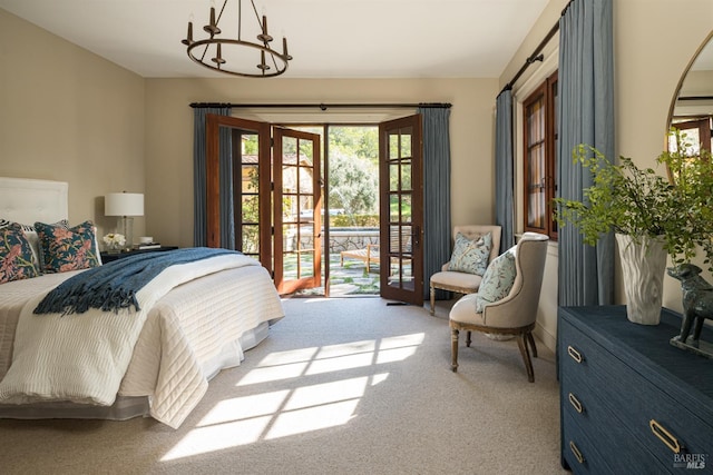 bedroom featuring an inviting chandelier, access to exterior, and light colored carpet