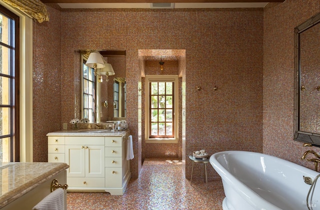 bathroom featuring vanity and a tub