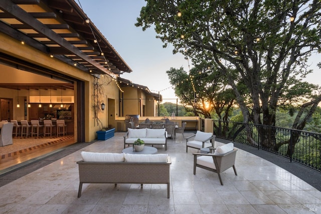 patio terrace at dusk featuring an outdoor living space