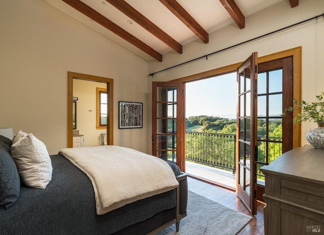 bedroom with wood-type flooring, vaulted ceiling with beams, and access to exterior