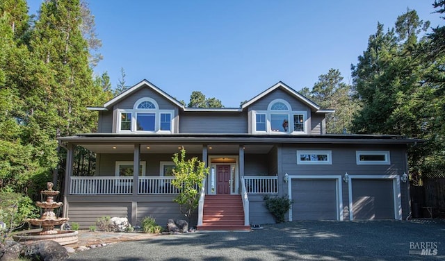 view of front of home with covered porch and a garage