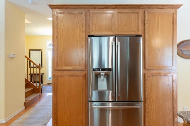 kitchen featuring light hardwood / wood-style floors and stainless steel fridge