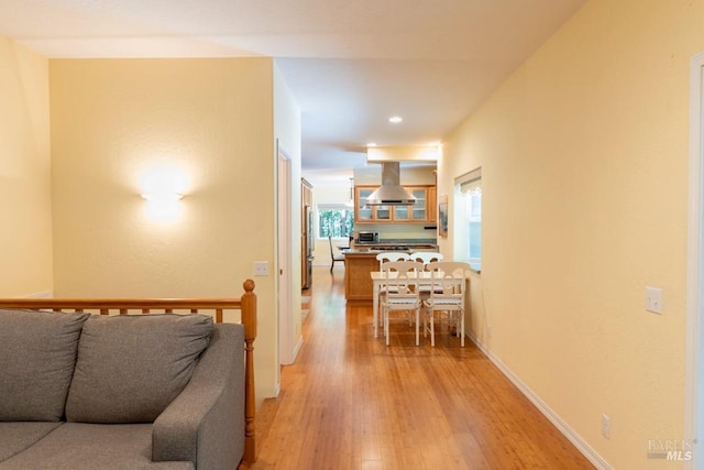 hallway with light hardwood / wood-style floors