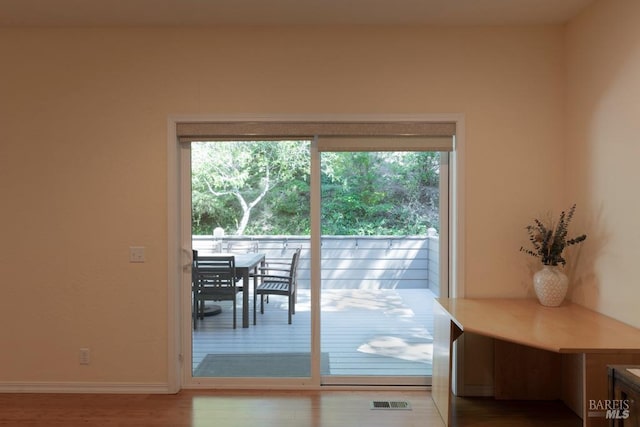 entryway with hardwood / wood-style flooring and a healthy amount of sunlight