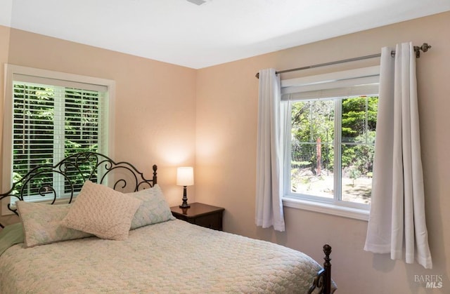 bedroom featuring multiple windows