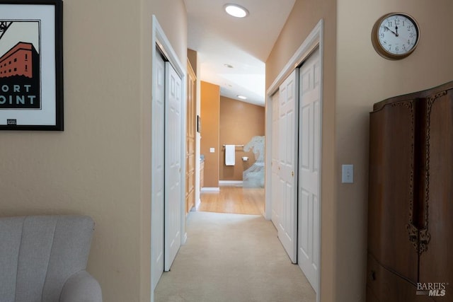 hallway featuring light carpet