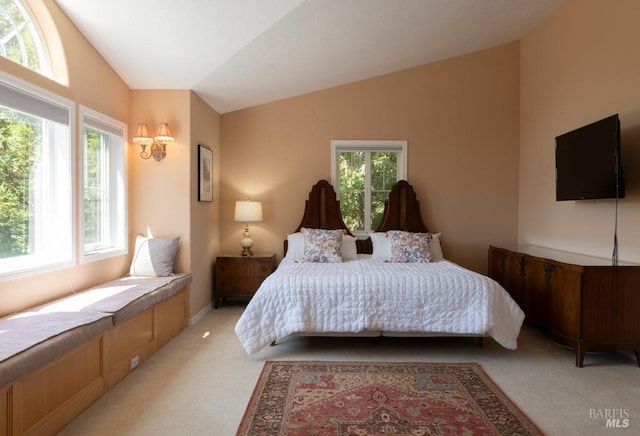 bedroom featuring lofted ceiling and light colored carpet