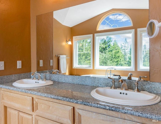 bathroom with vanity and vaulted ceiling