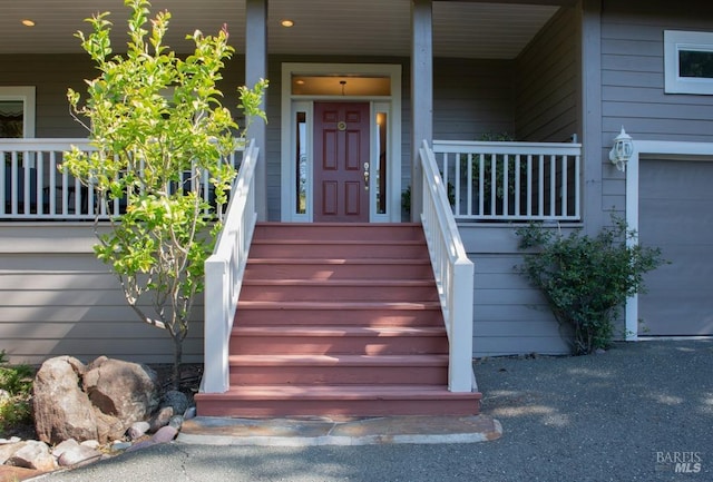 view of exterior entry featuring covered porch