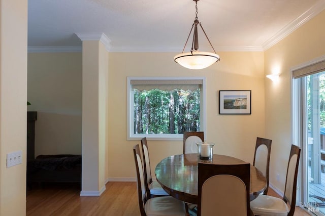 dining area featuring light hardwood / wood-style floors and ornamental molding