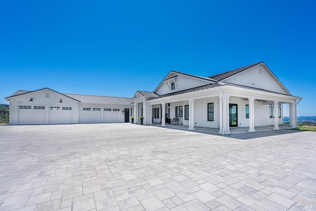 view of front of house featuring covered porch and a garage