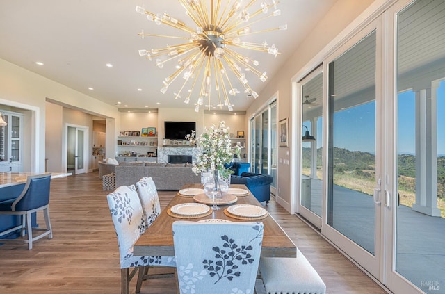 dining area featuring french doors, a chandelier, and light wood-type flooring