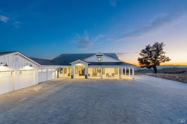 modern farmhouse with a porch and a garage