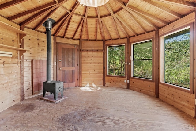 interior space featuring wood ceiling, a wood stove, and vaulted ceiling with beams