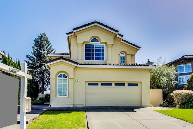 mediterranean / spanish-style house with a garage