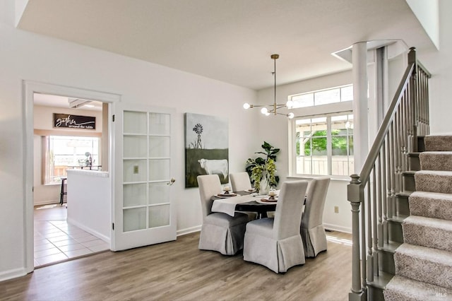 dining area with a notable chandelier and hardwood / wood-style flooring