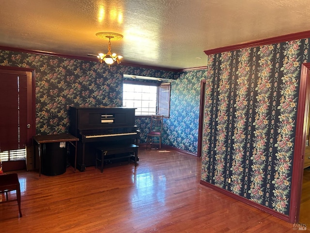 misc room with hardwood / wood-style floors and a chandelier