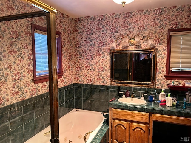 bathroom with tiled bath and vanity