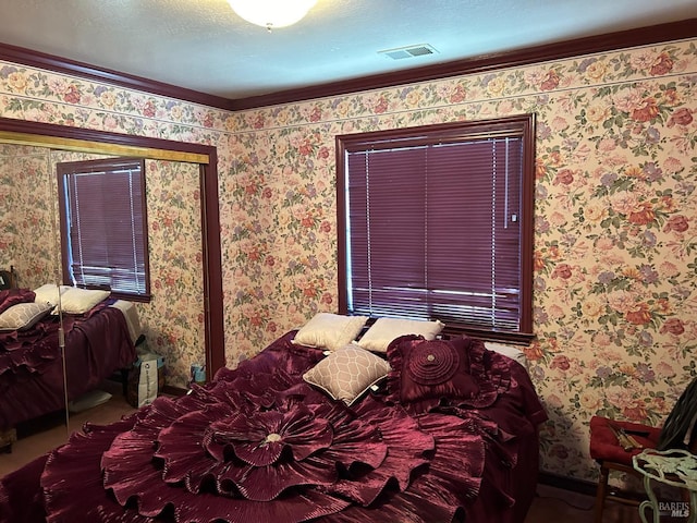 bedroom featuring a textured ceiling and ornamental molding