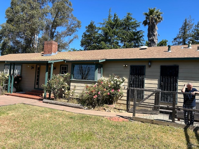 ranch-style house featuring a front lawn