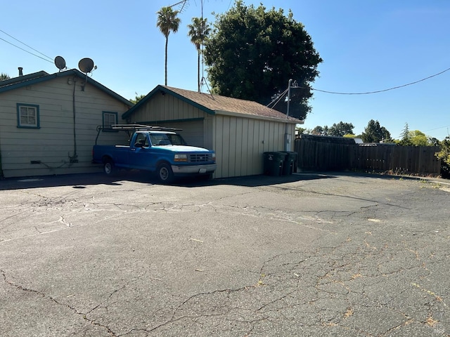 view of side of home with a garage and an outdoor structure