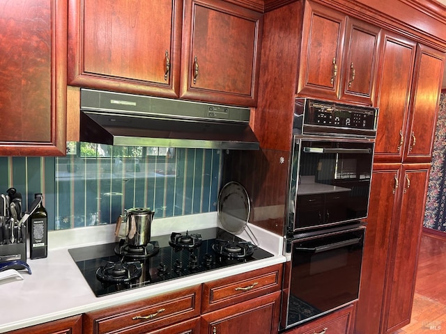 kitchen with black appliances and light hardwood / wood-style floors