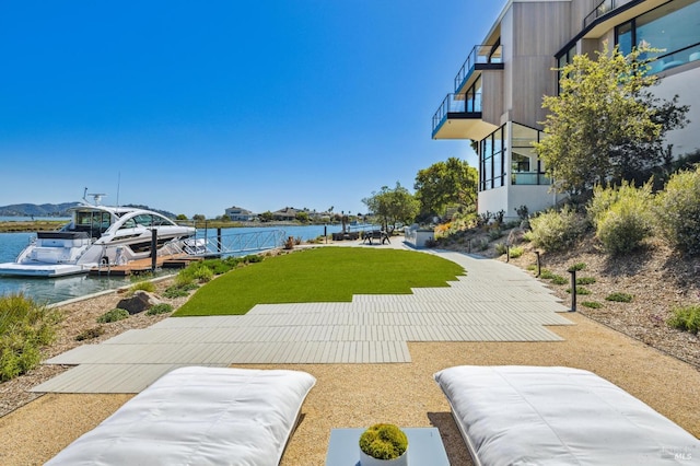 view of property's community featuring a water view and a yard