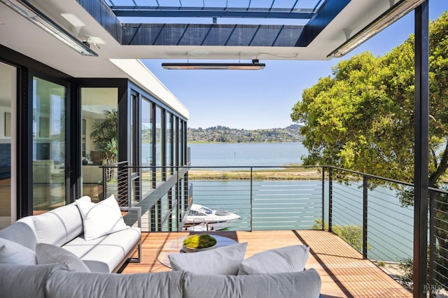 balcony with a water view and an outdoor hangout area