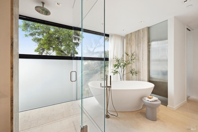 bathroom featuring expansive windows, plus walk in shower, and tile patterned floors