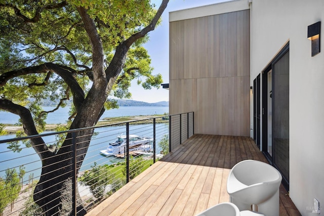 wooden terrace with a water and mountain view