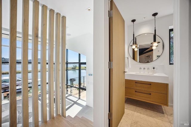 bathroom with vanity, plenty of natural light, and a water view