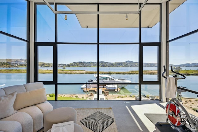 sunroom with a water view and plenty of natural light