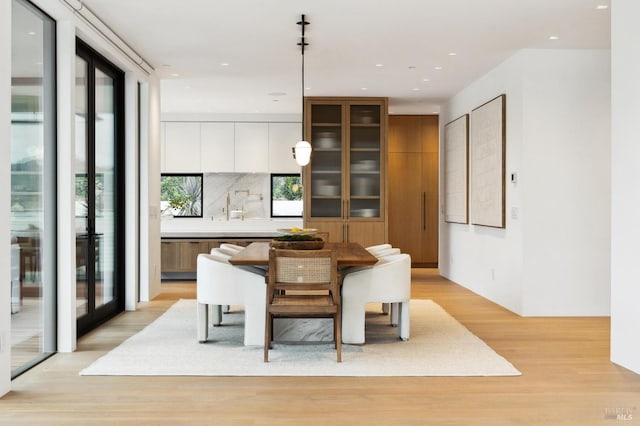 dining space with light hardwood / wood-style flooring