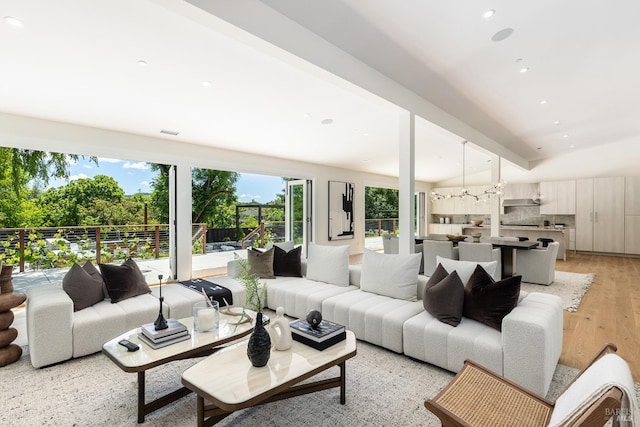 living room featuring light hardwood / wood-style flooring and beamed ceiling