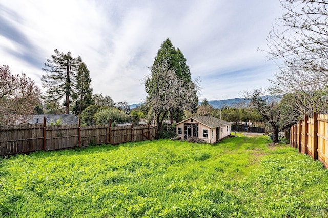 view of yard featuring a fenced backyard and a mountain view