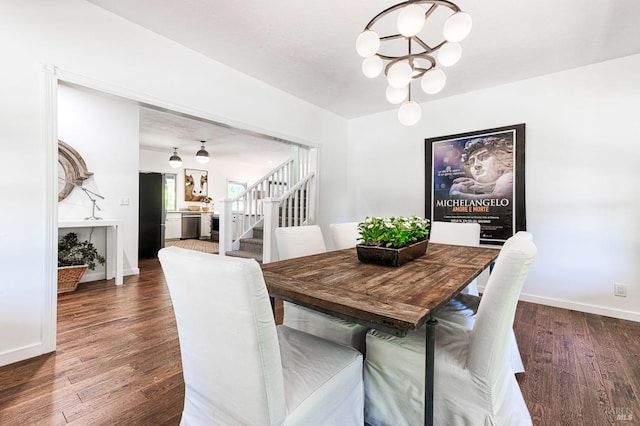 dining space with stairway, a notable chandelier, wood finished floors, and baseboards