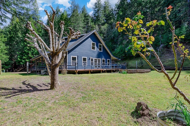 view of front of house with a front yard and a deck