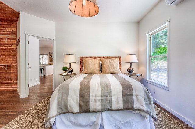 bedroom with dark hardwood / wood-style floors and wooden walls