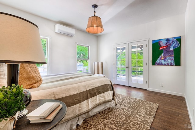 bedroom featuring a wall unit AC, dark hardwood / wood-style floors, multiple windows, and access to outside