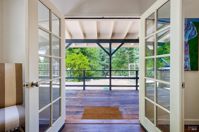 doorway to outside with beam ceiling, french doors, and hardwood / wood-style flooring