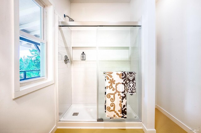 bathroom with a shower with shower door