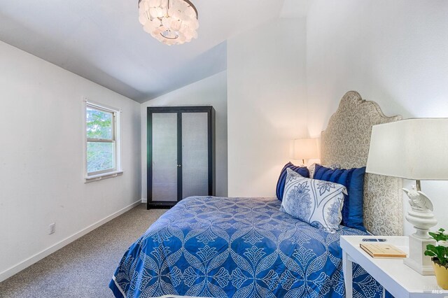 carpeted bedroom with lofted ceiling