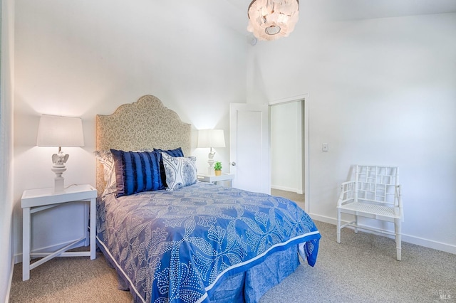 carpeted bedroom with baseboards and an inviting chandelier