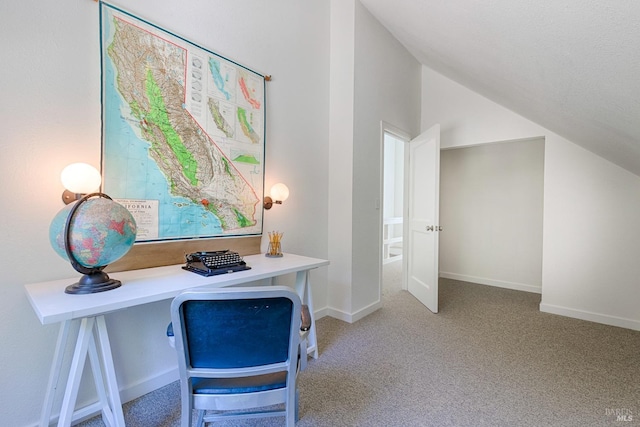 office area with baseboards, lofted ceiling, and light carpet