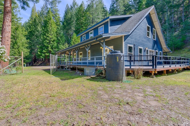 exterior space with a wooden deck and a front yard